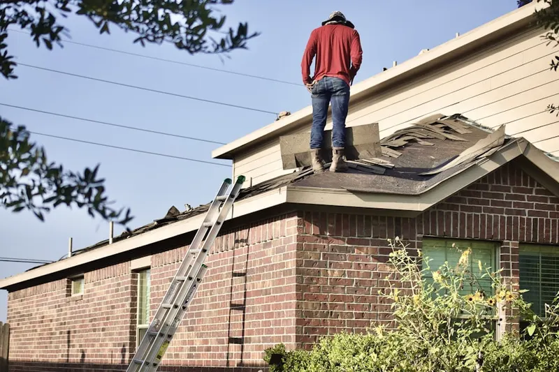 Professional roofer working on a residential roof in Brookeville